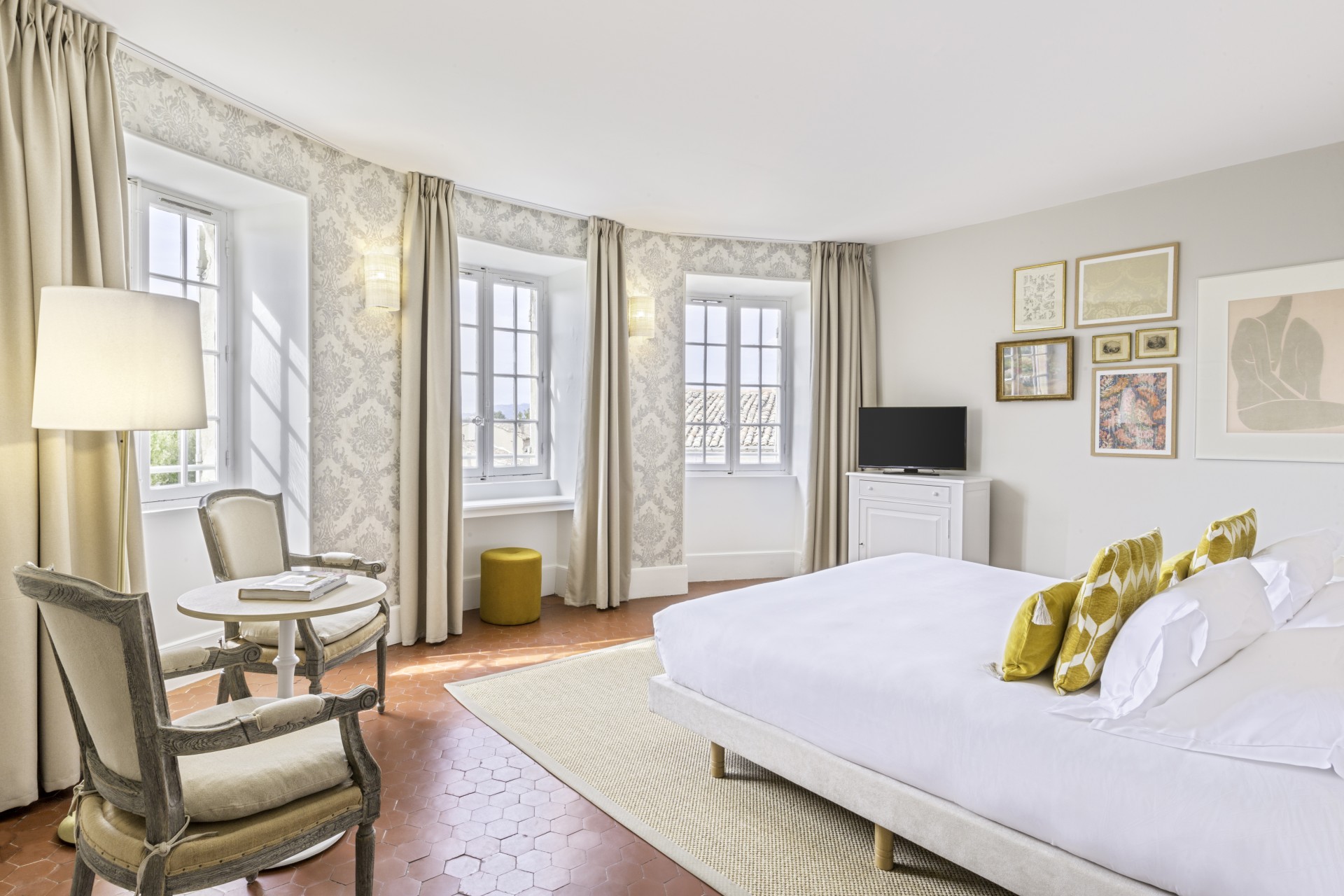 a bedroom with a bed and chairs