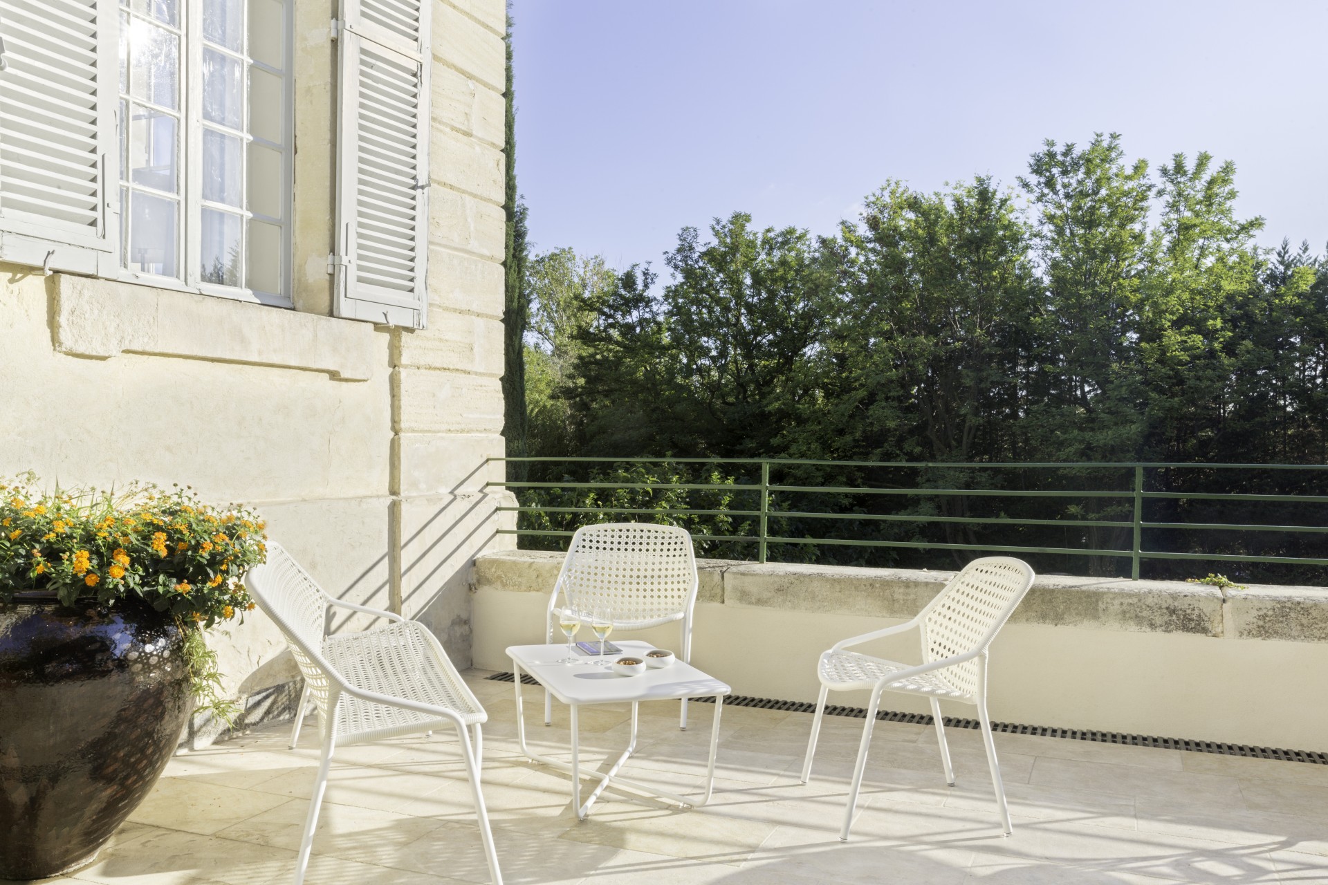 a white chairs and a table on a patio