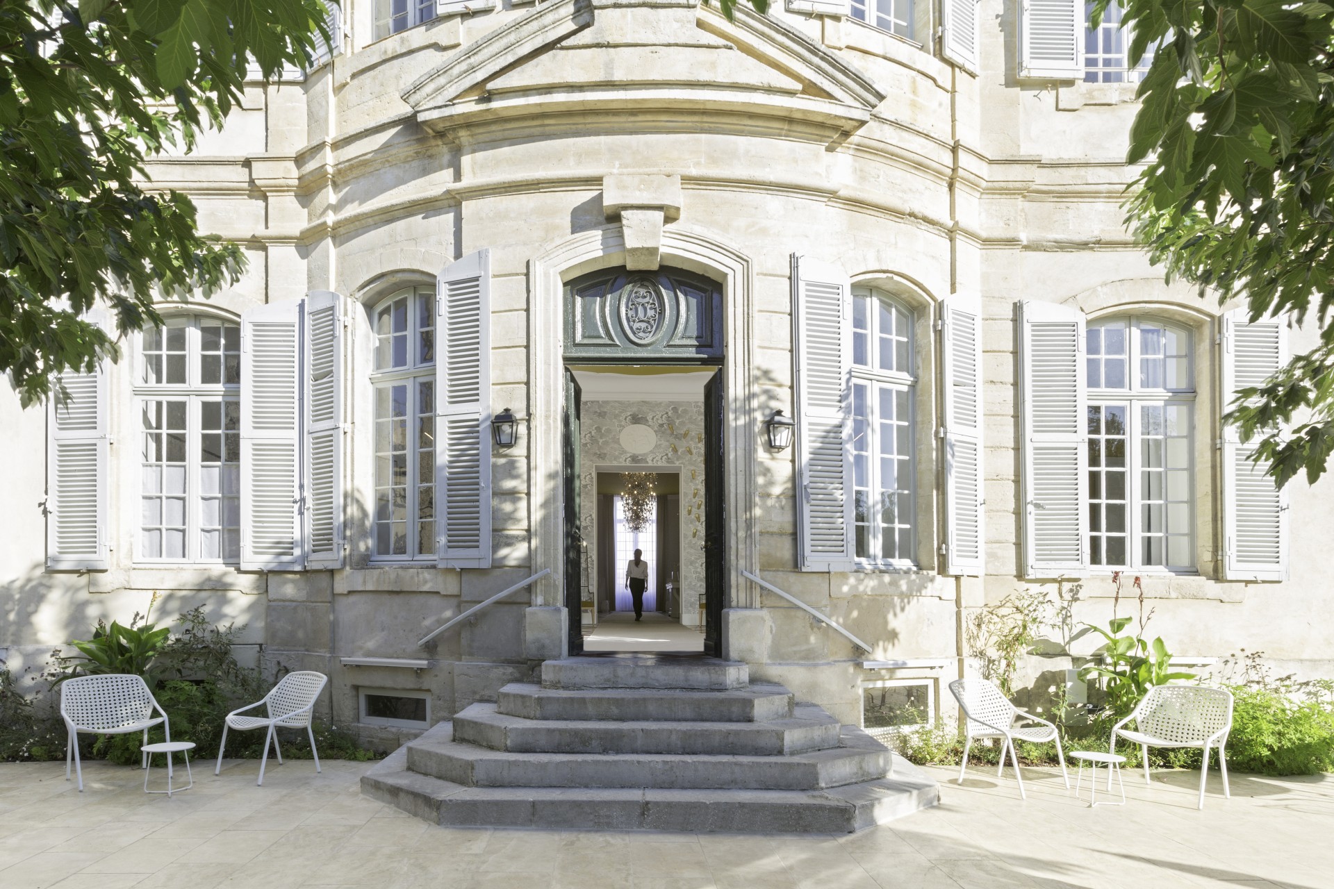 a building with stairs and a person in the doorway