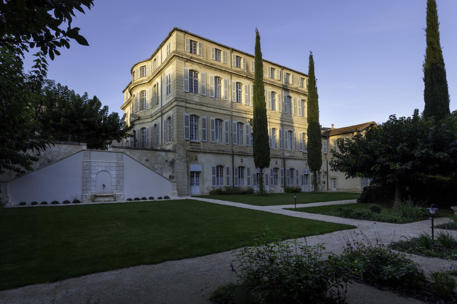 a building with a lawn and trees