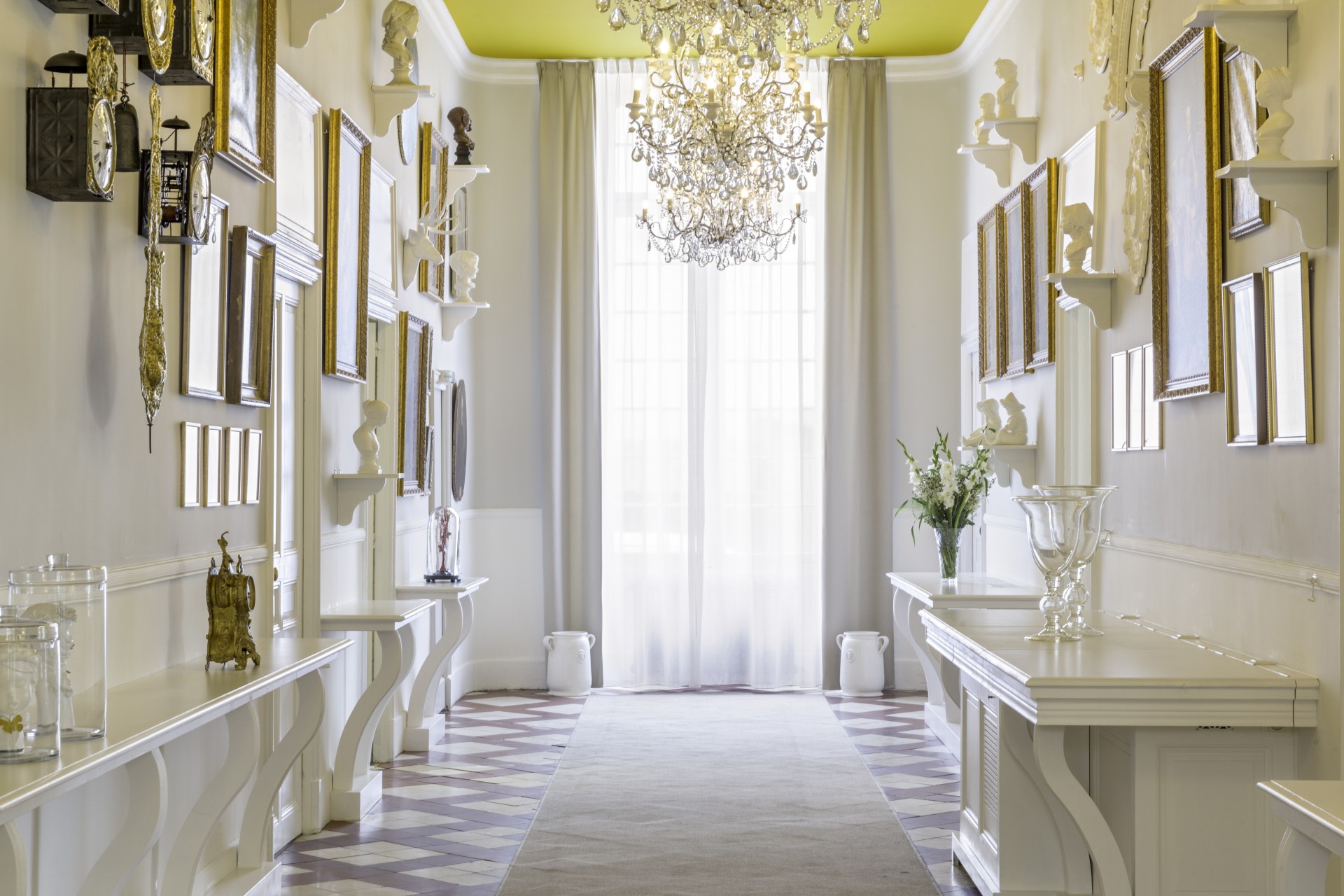 a room with a chandelier and shelves