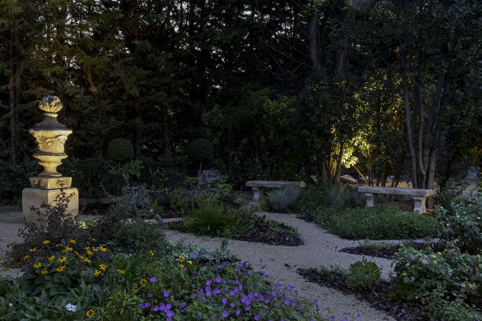 a garden with benches and flowers