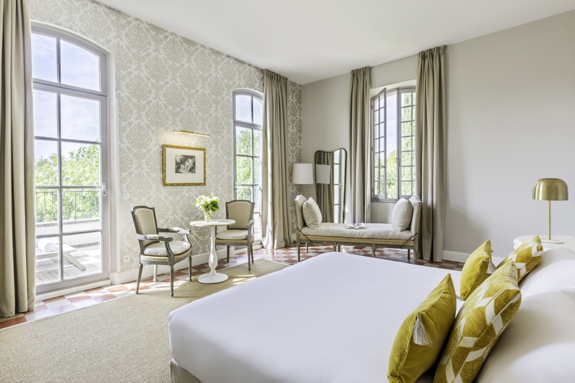 a room with a bed and chairs
