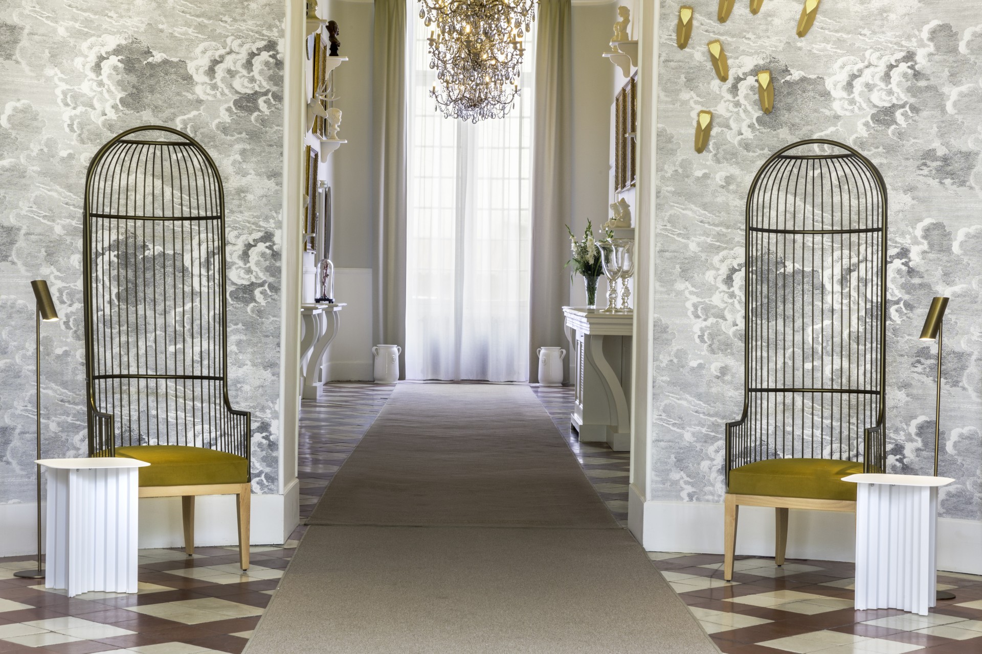 a hallway with a chandelier and a mirror