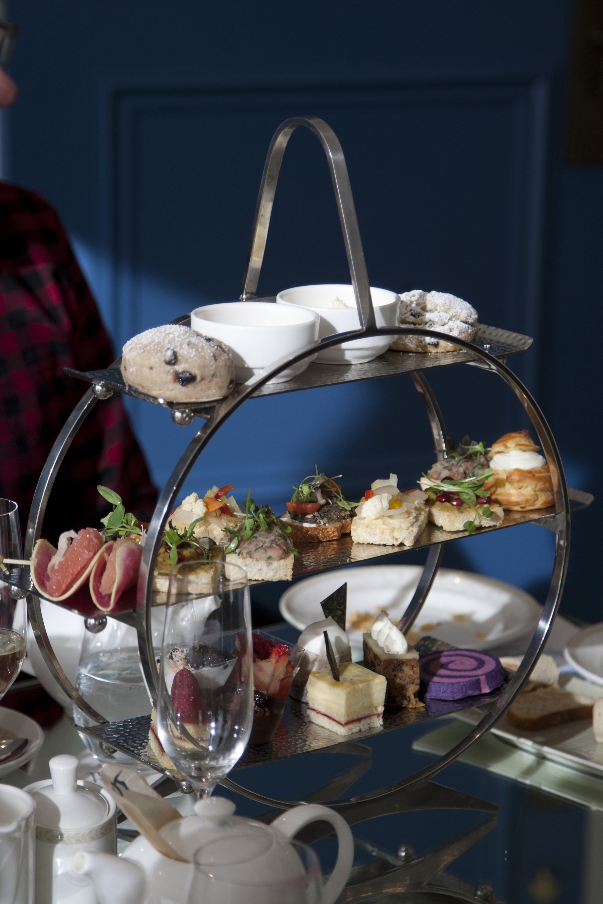 a metal tiered tray with food on it