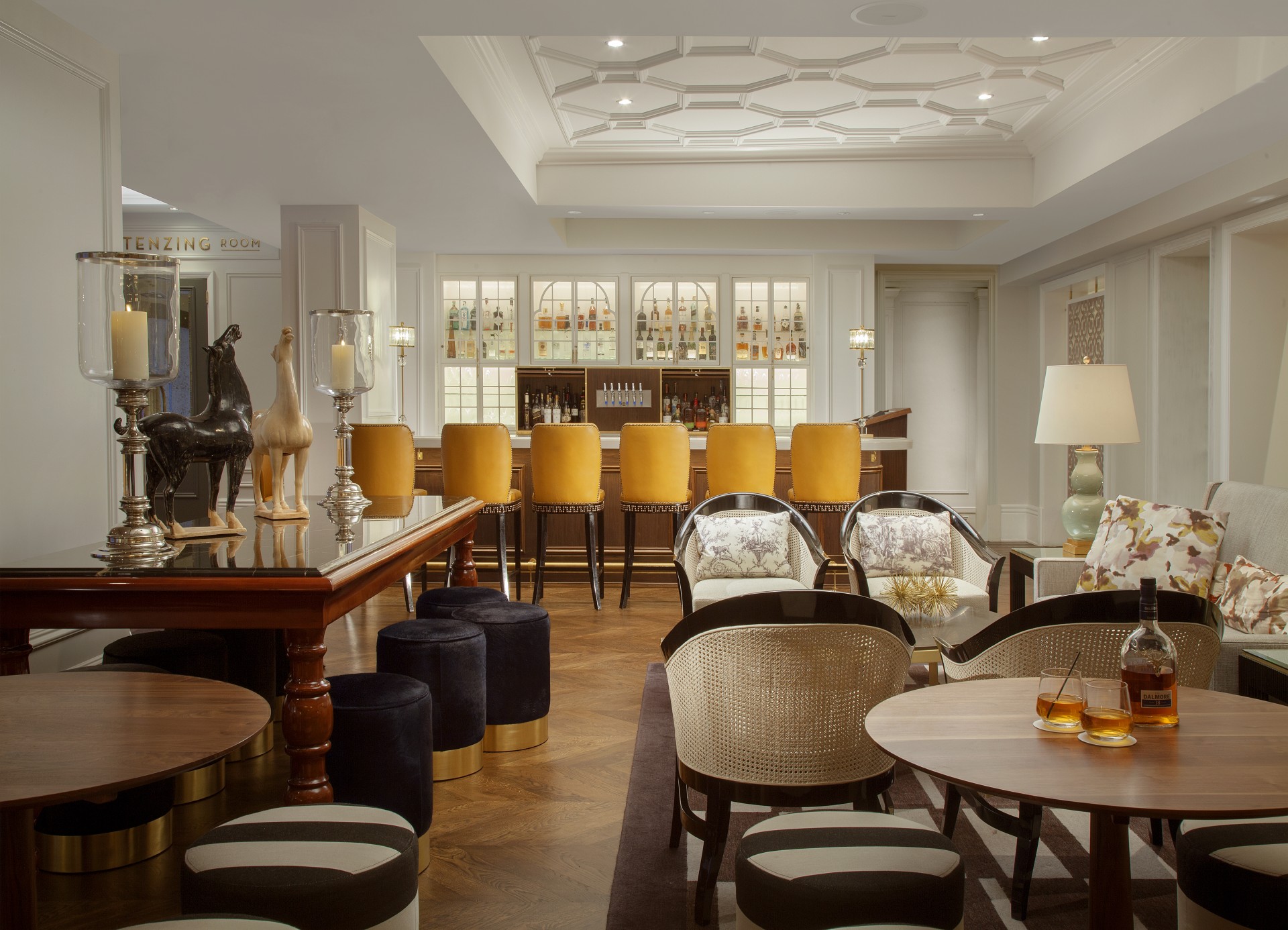 a room with a bar and chairs