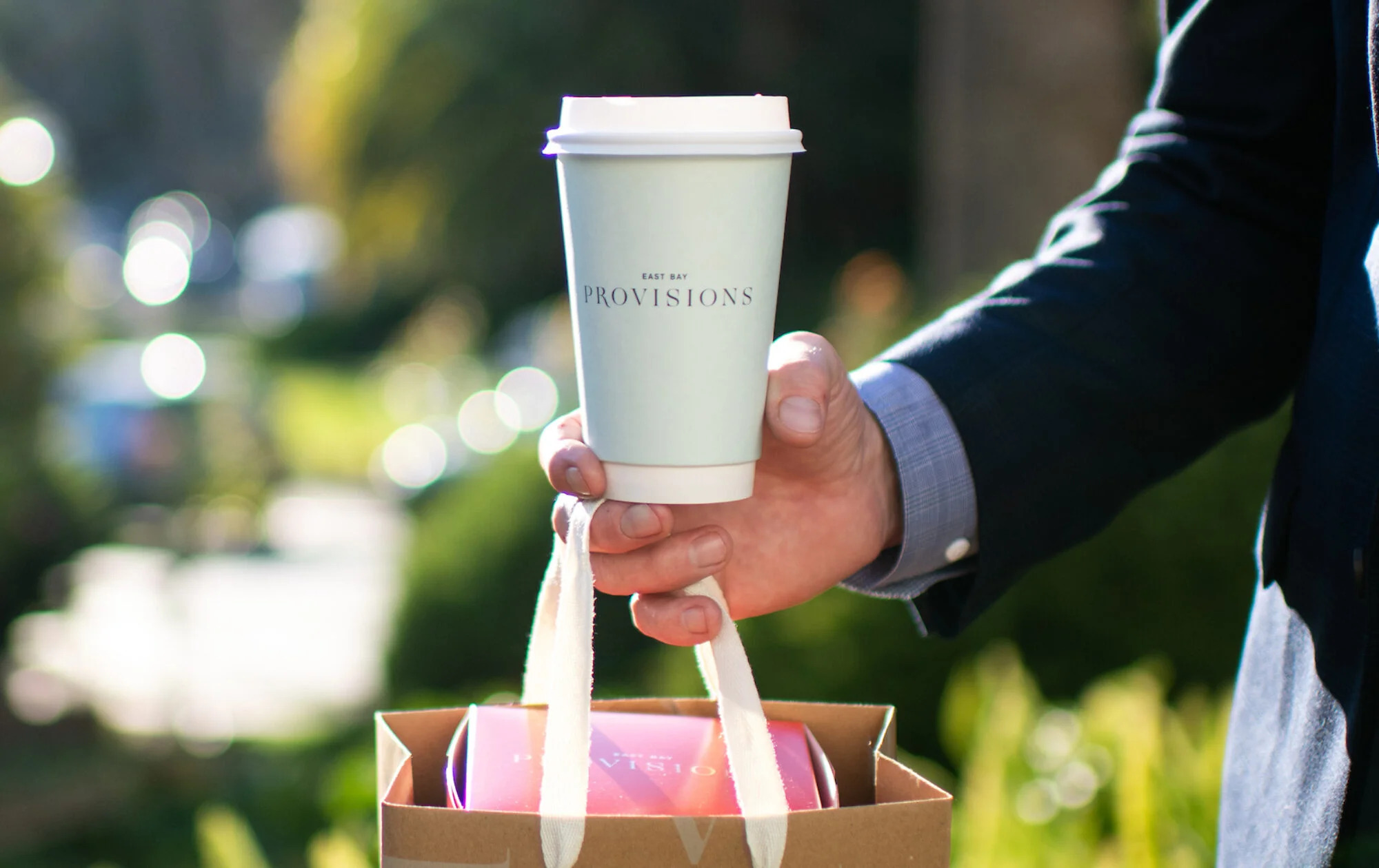 a hand holding a cup of coffee