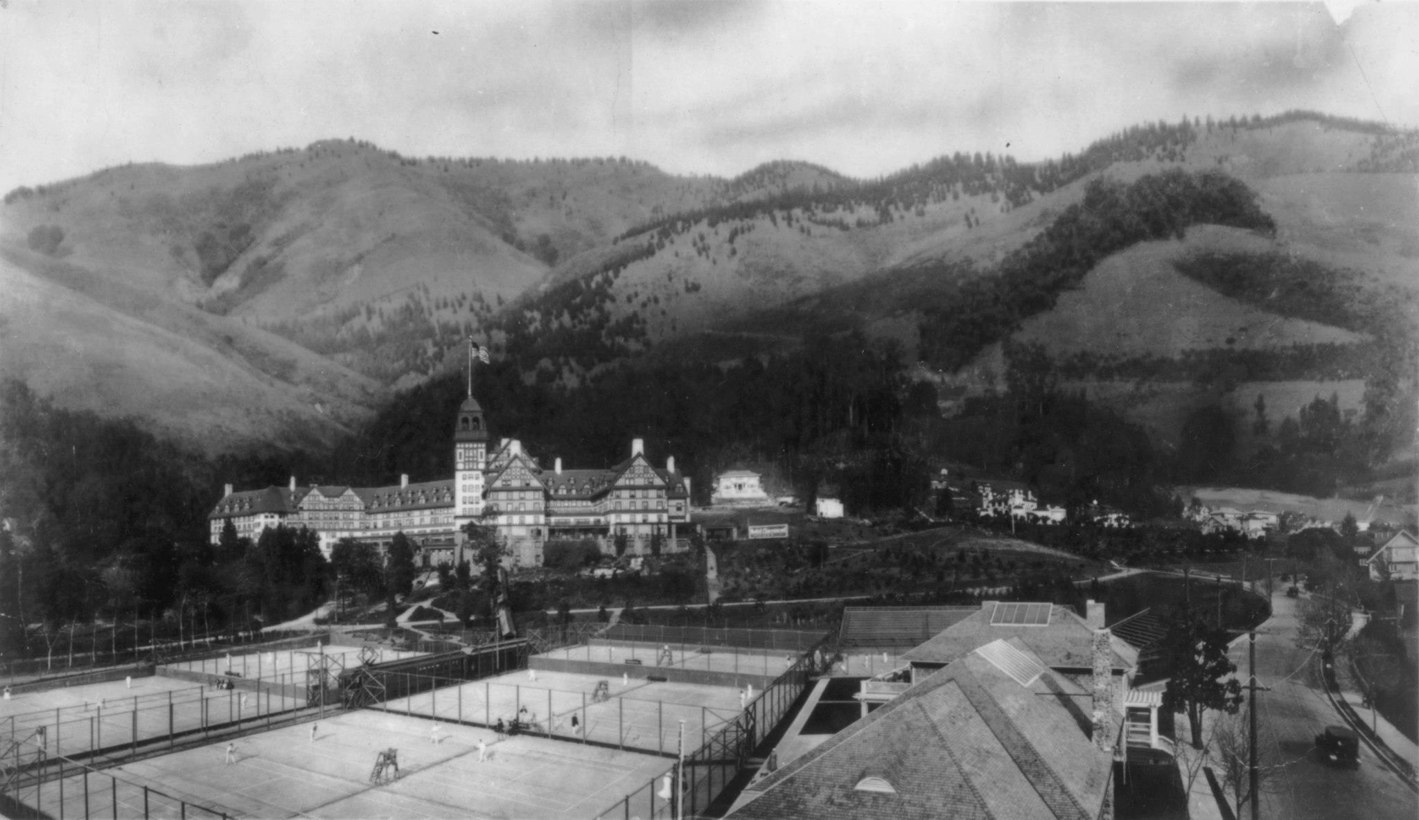 a tennis court with a building in the background