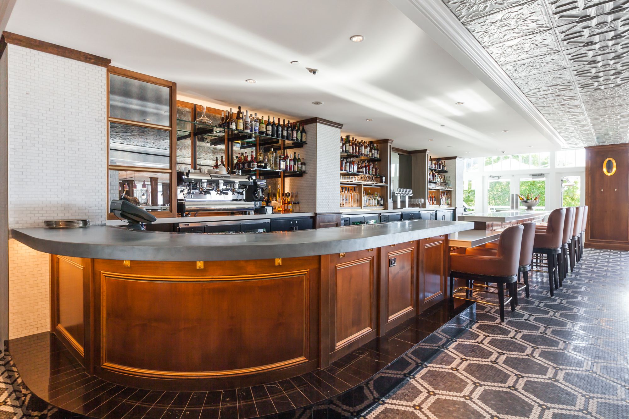 a bar with a counter and chairs
