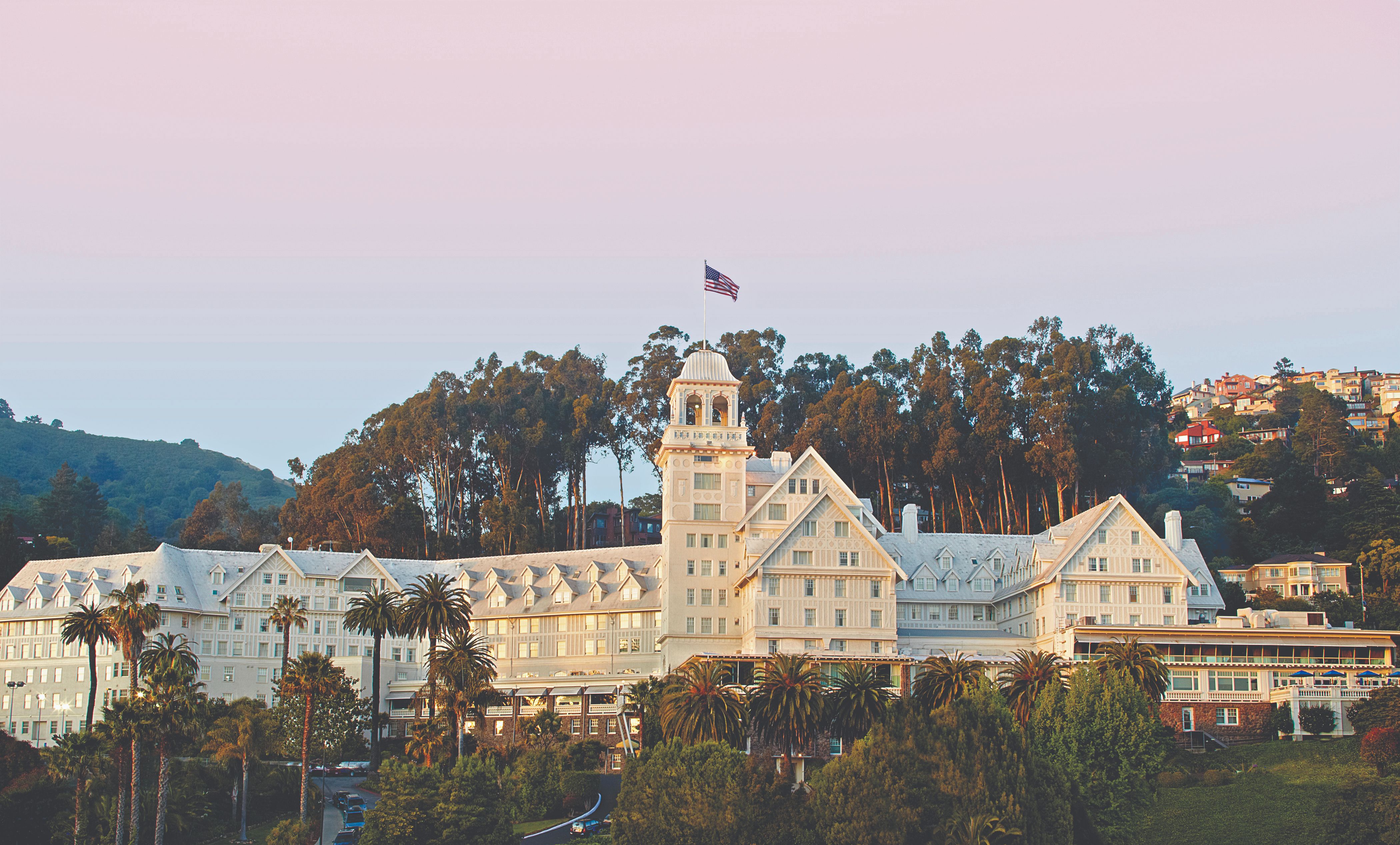 a large white building with a flag on top