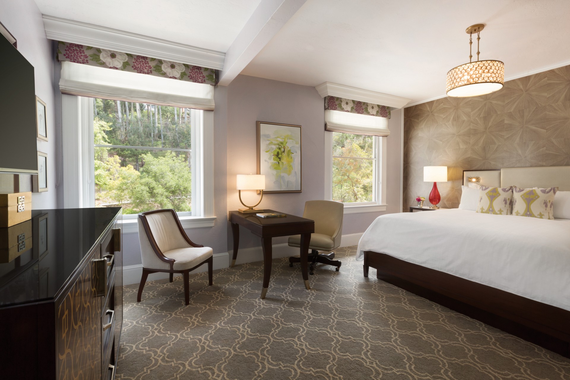 a room with a bed and a desk and chairs