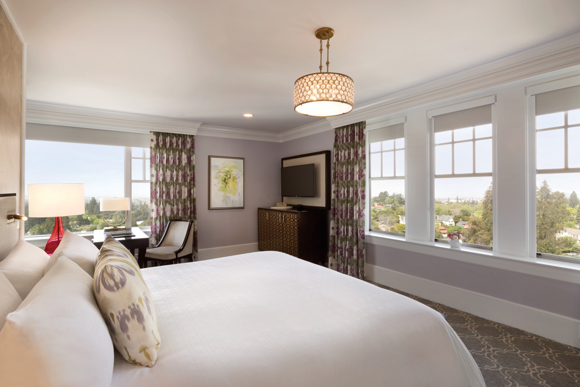 a bedroom with a bed and a television