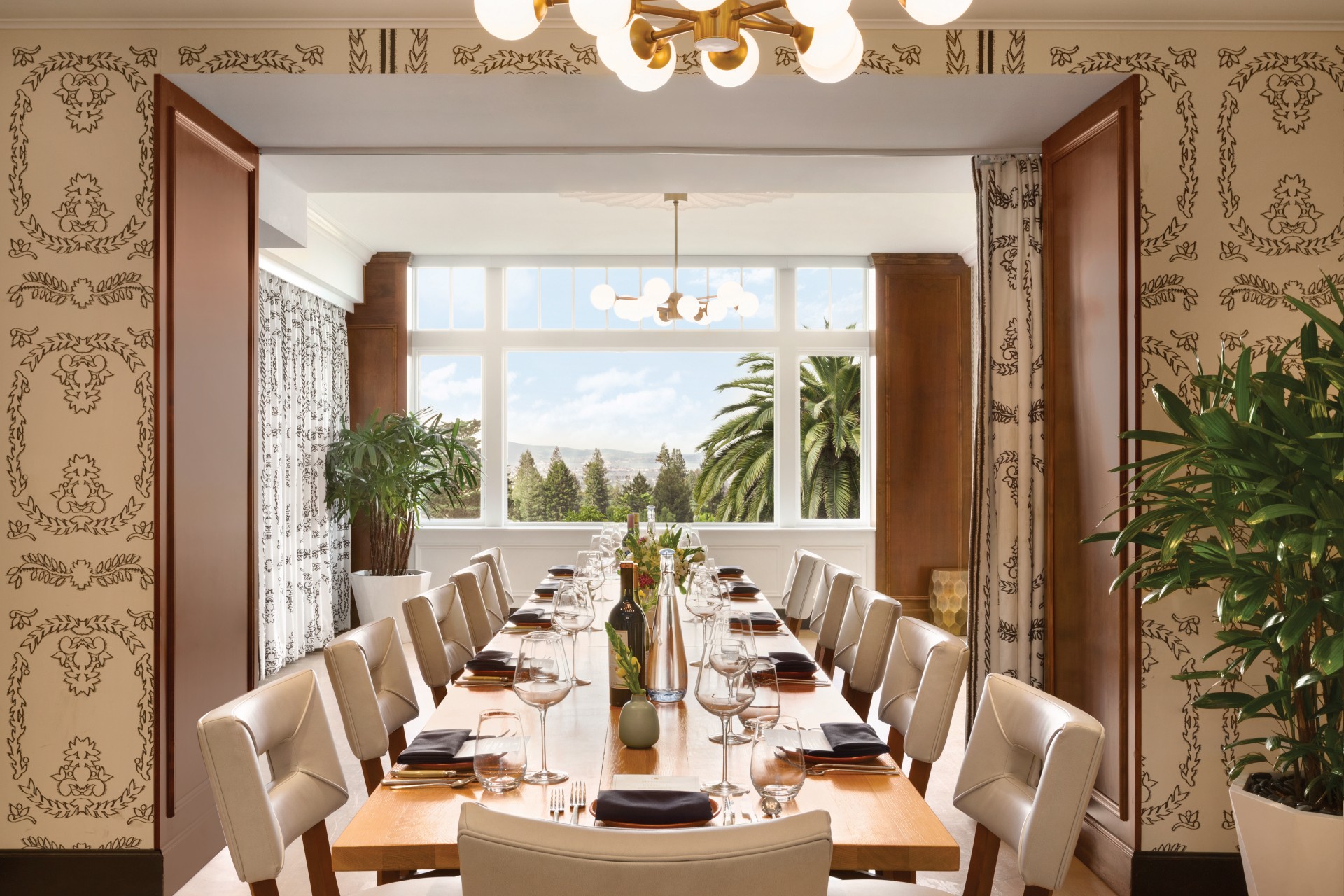 a long table with wine glasses and bottles on it