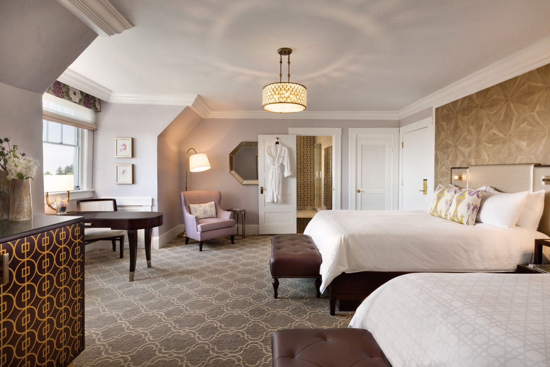 a room with a bed and chairs