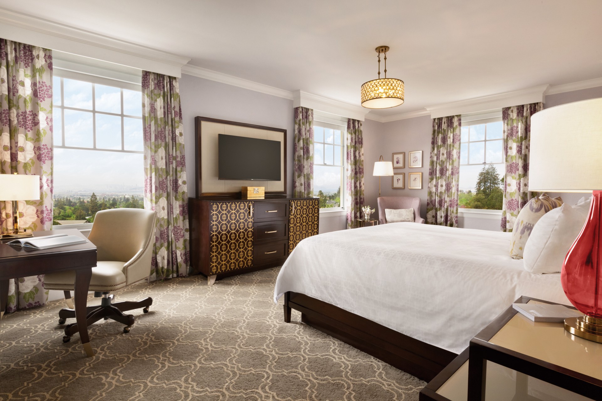 a bedroom with a bed and a television