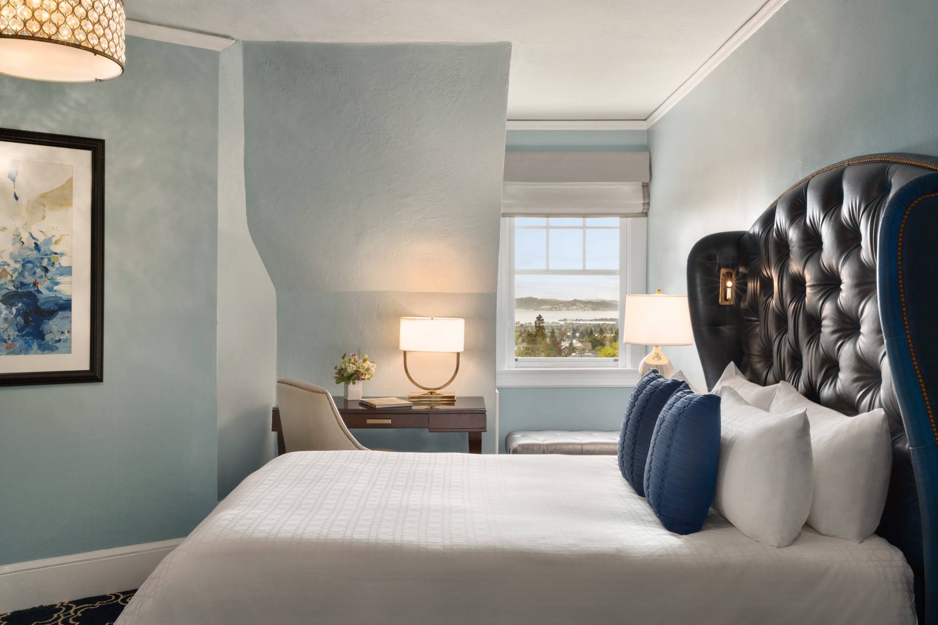 a bed with a lamp and a table