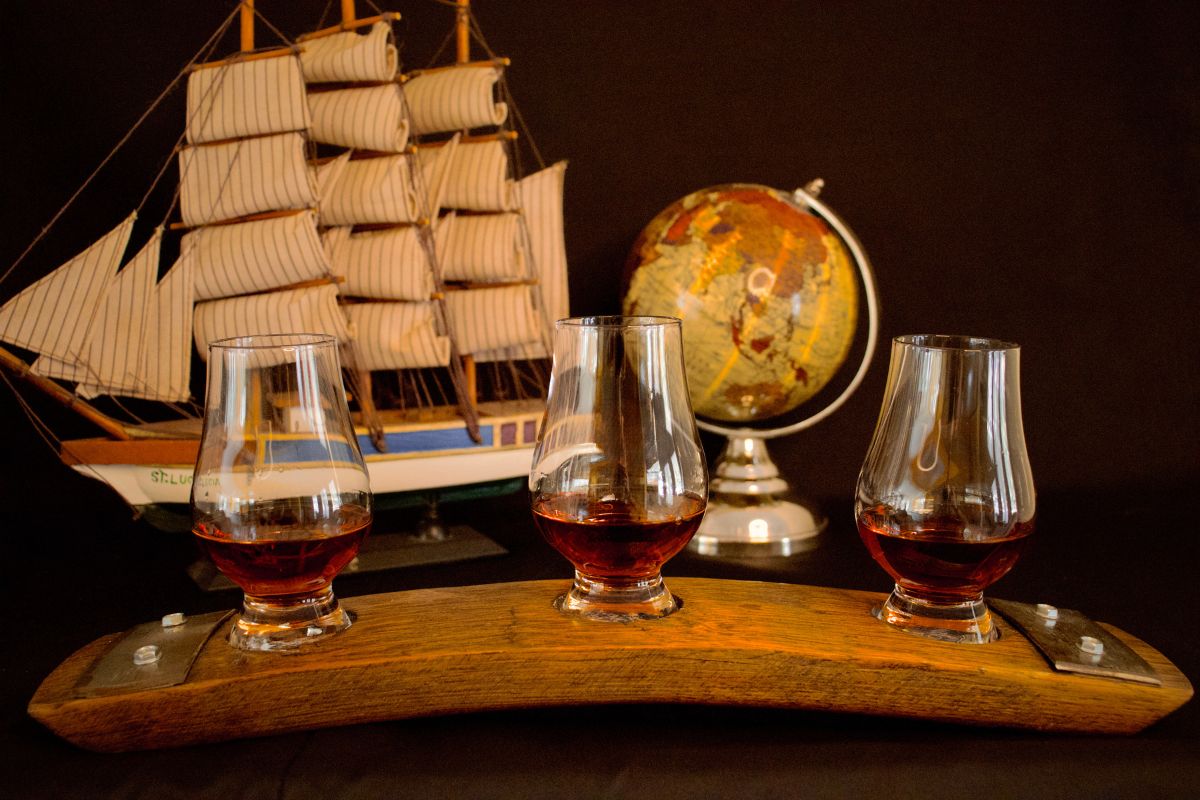 a group of glasses of alcohol on a wooden board