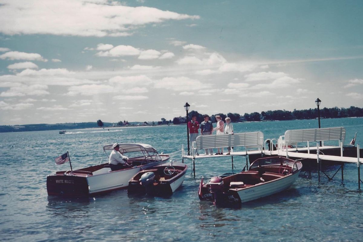 a group of people on a dock with boats