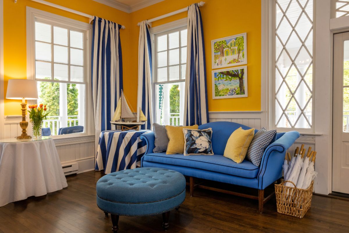 a room with yellow walls and blue couch