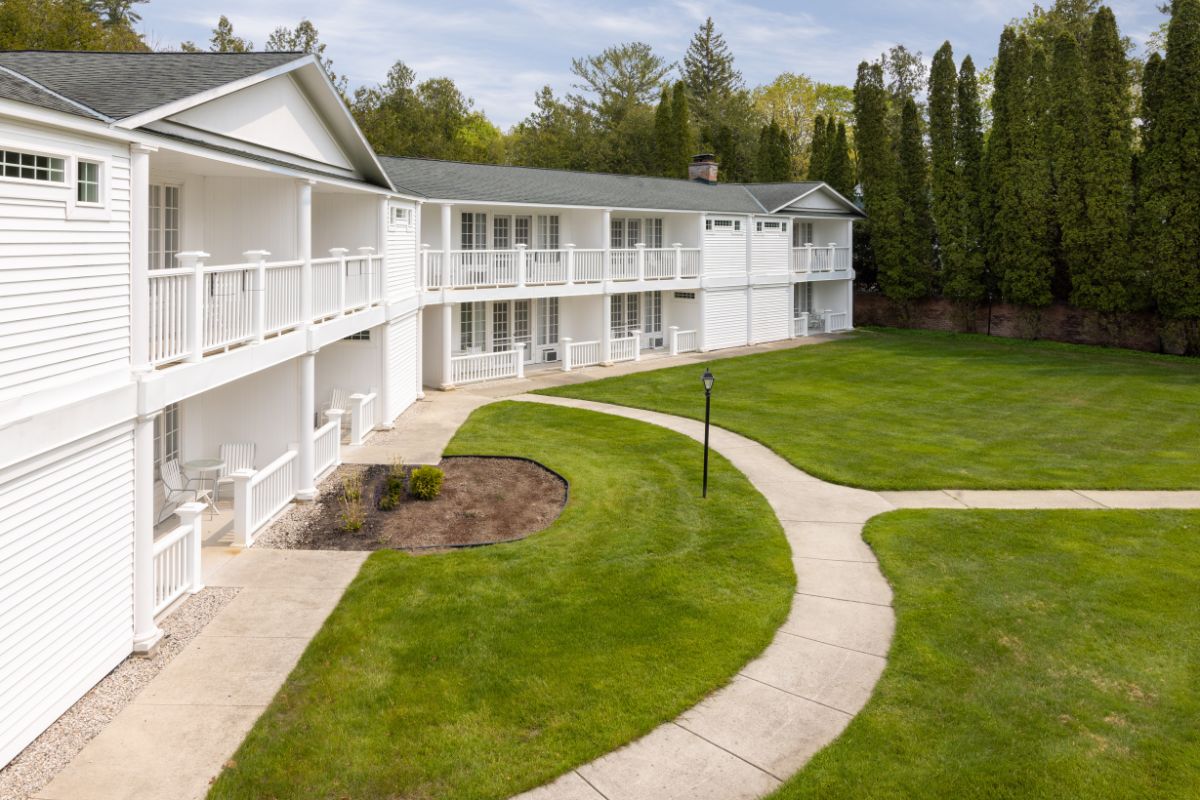 a building with a lawn and a walkway