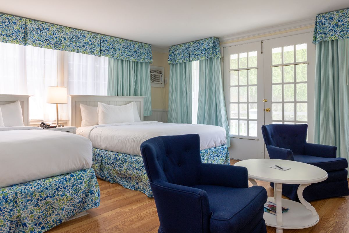 a room with two beds and a table