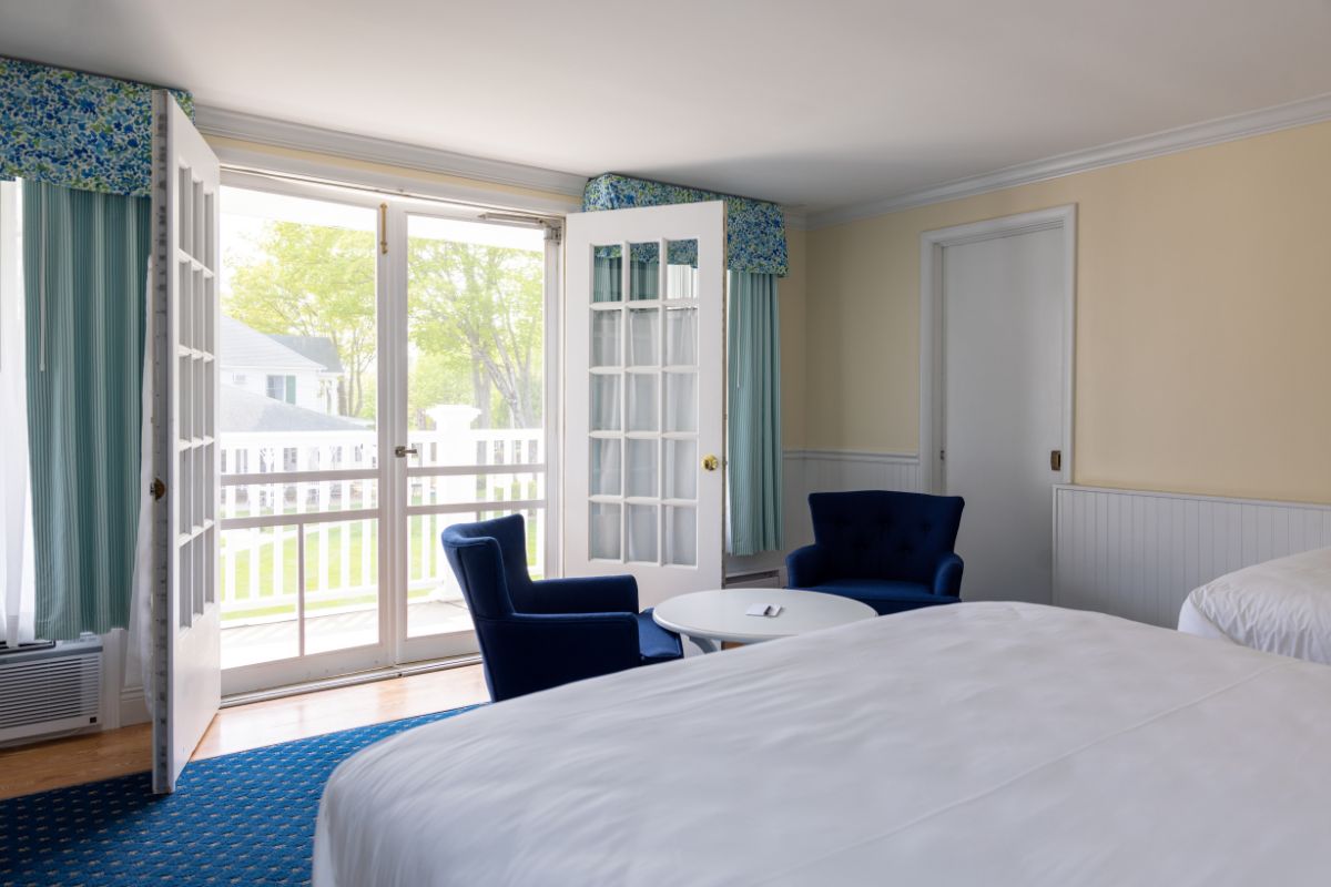 a bedroom with a bed and chairs