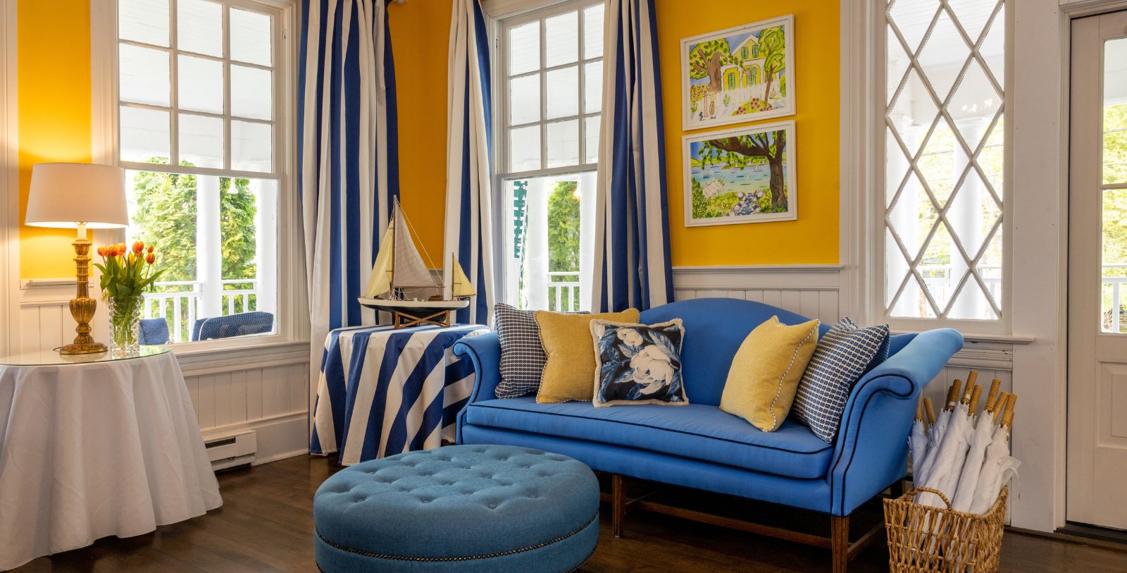 a blue couch with yellow pillows in a room