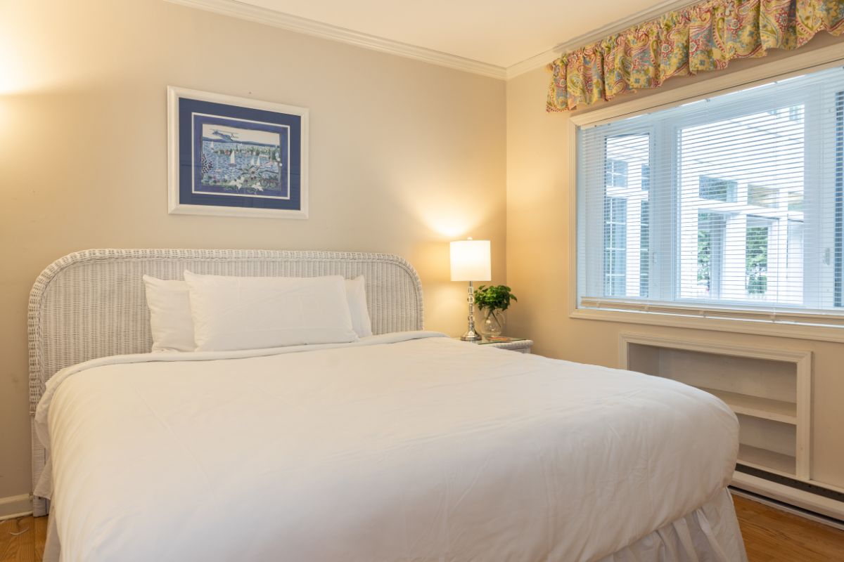 a bed with a lamp and a window