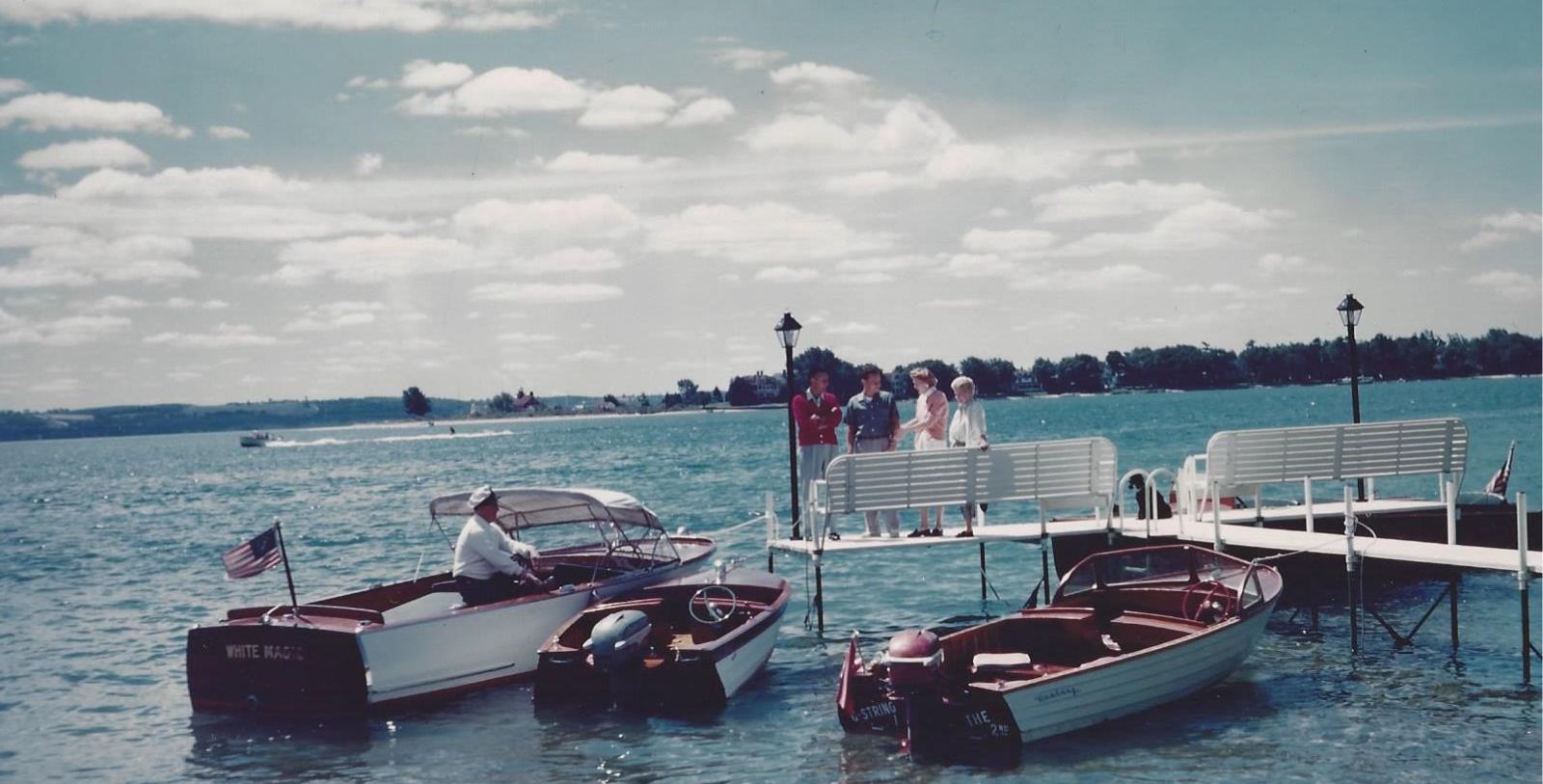 a group of people on a dock with boats