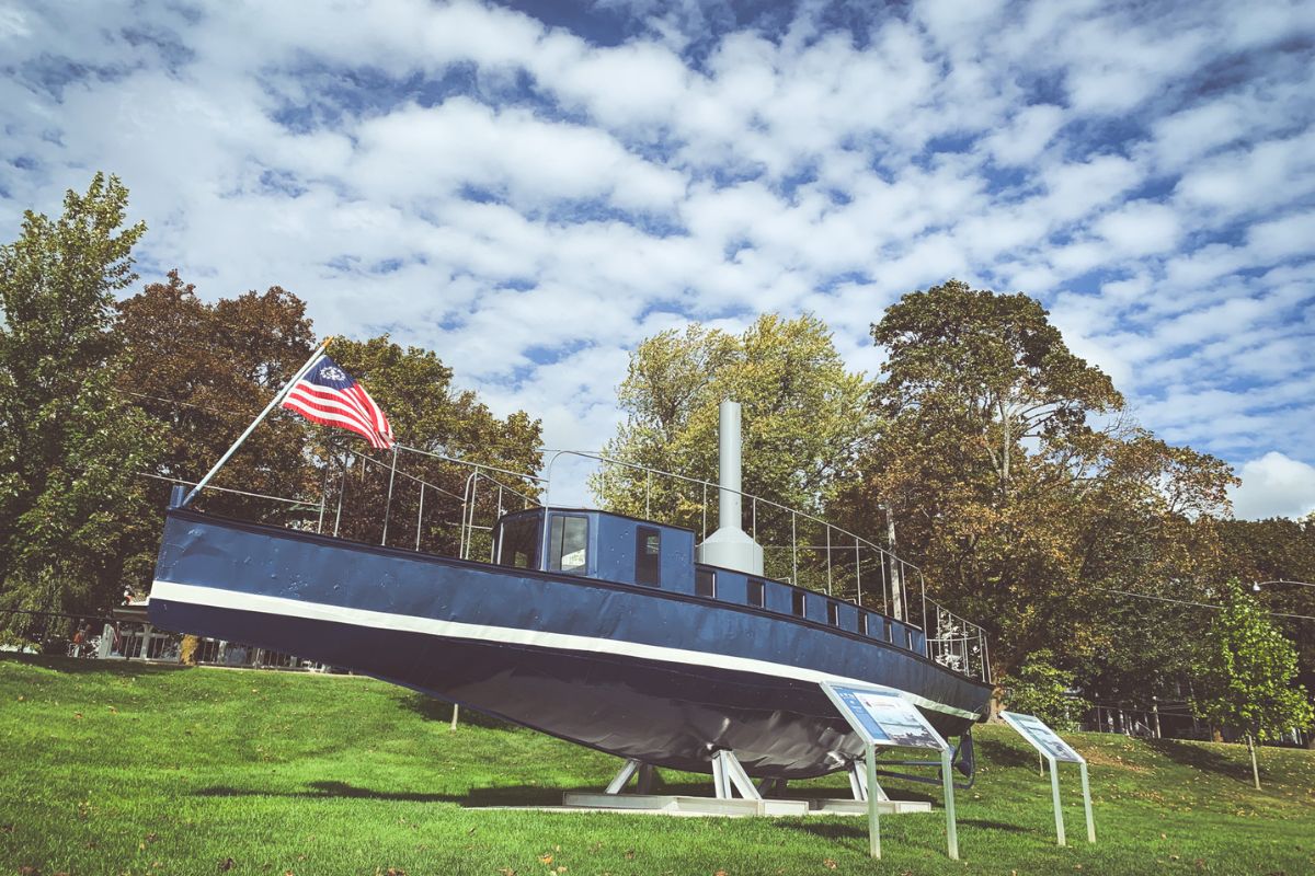 a boat on display in grass