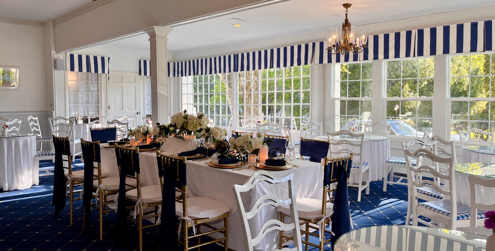 a dining room with a table set with chairs and a chandelier