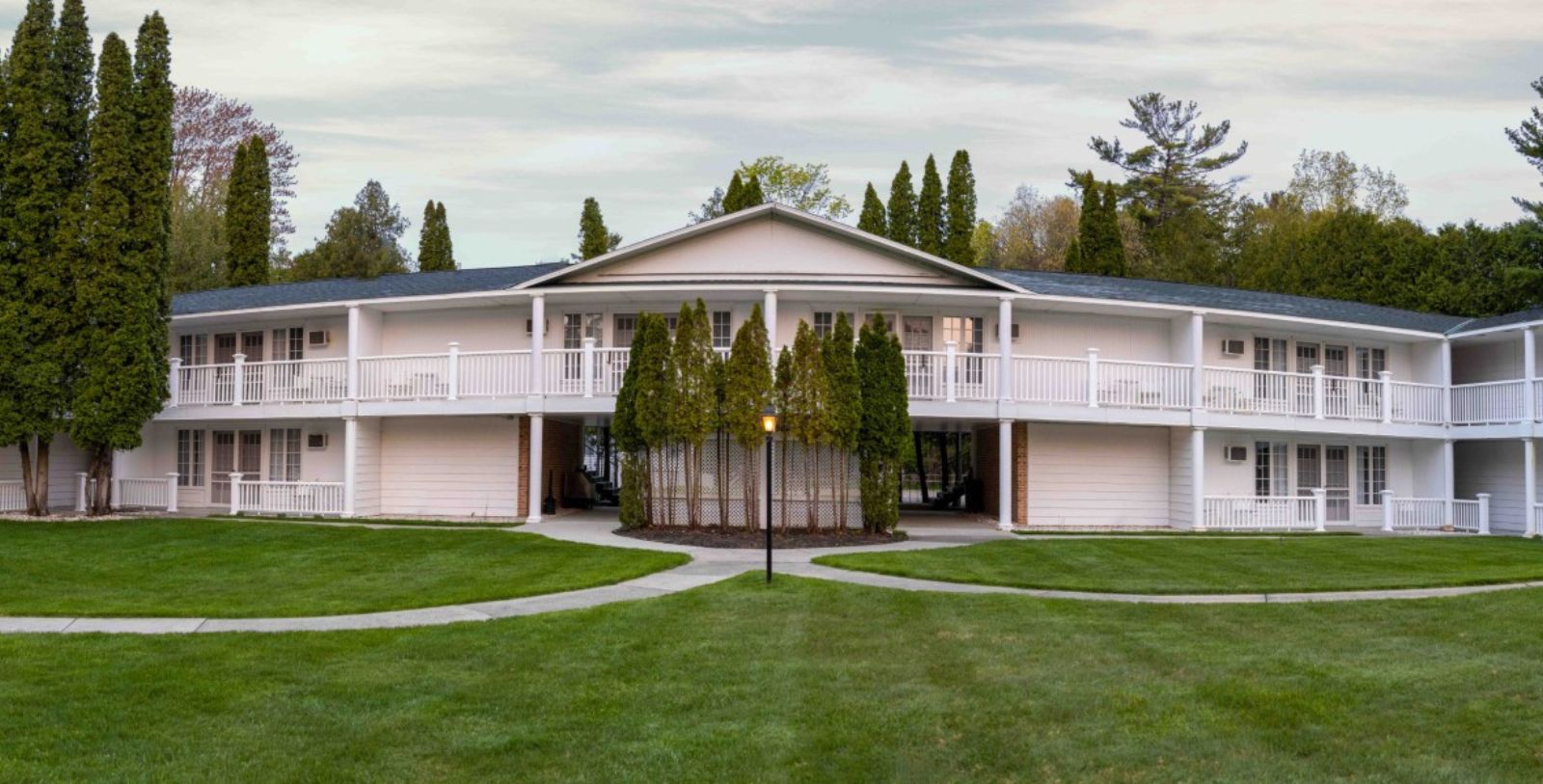 a house with a lawn and trees
