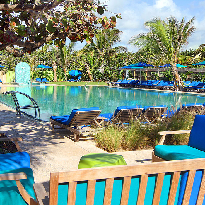 a pool with chairs and umbrellas