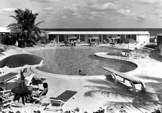 a pool with people sitting around it