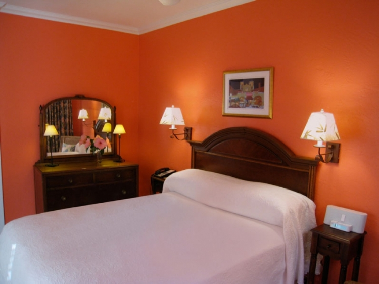 a bedroom with a bed and a mirror