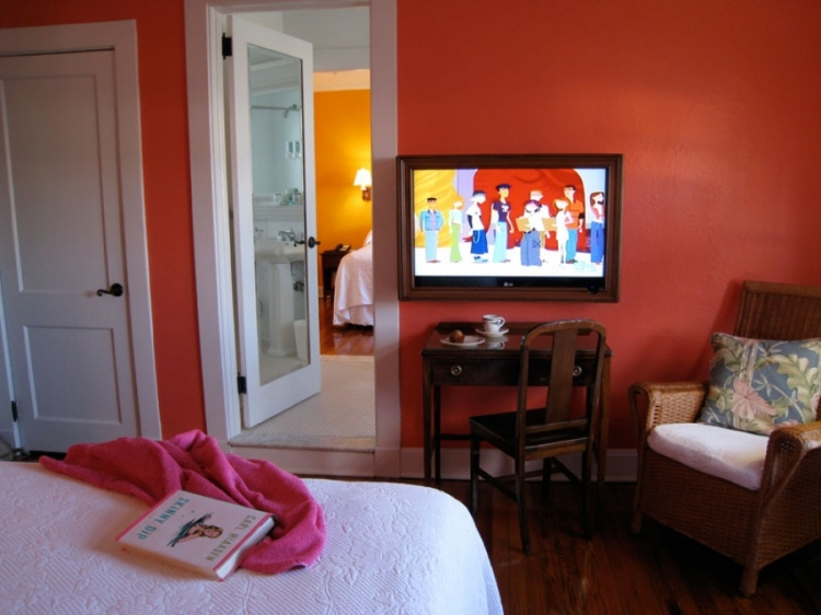 a bedroom with a tv and a bed