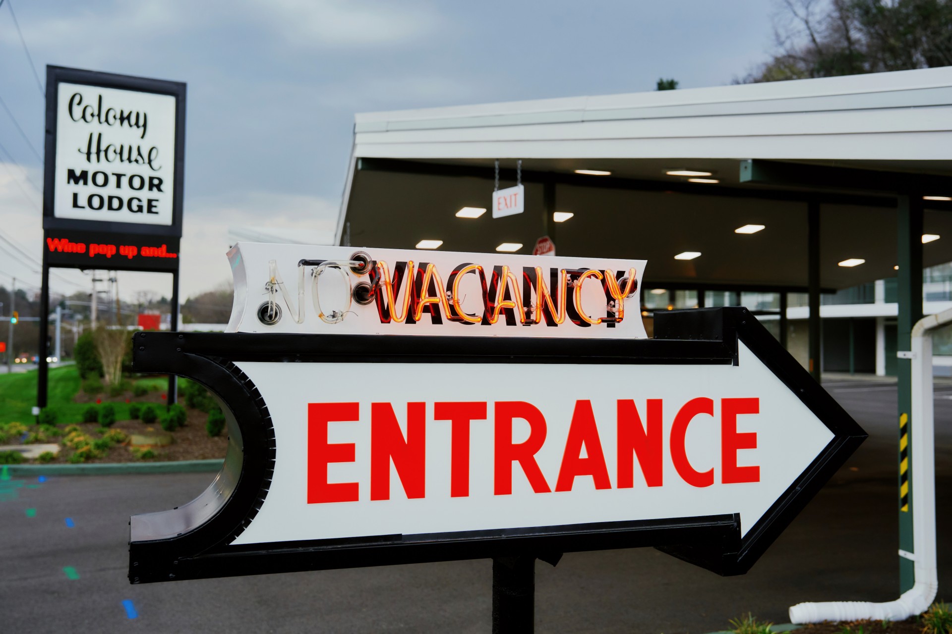 a sign with an arrow pointing to an entrance