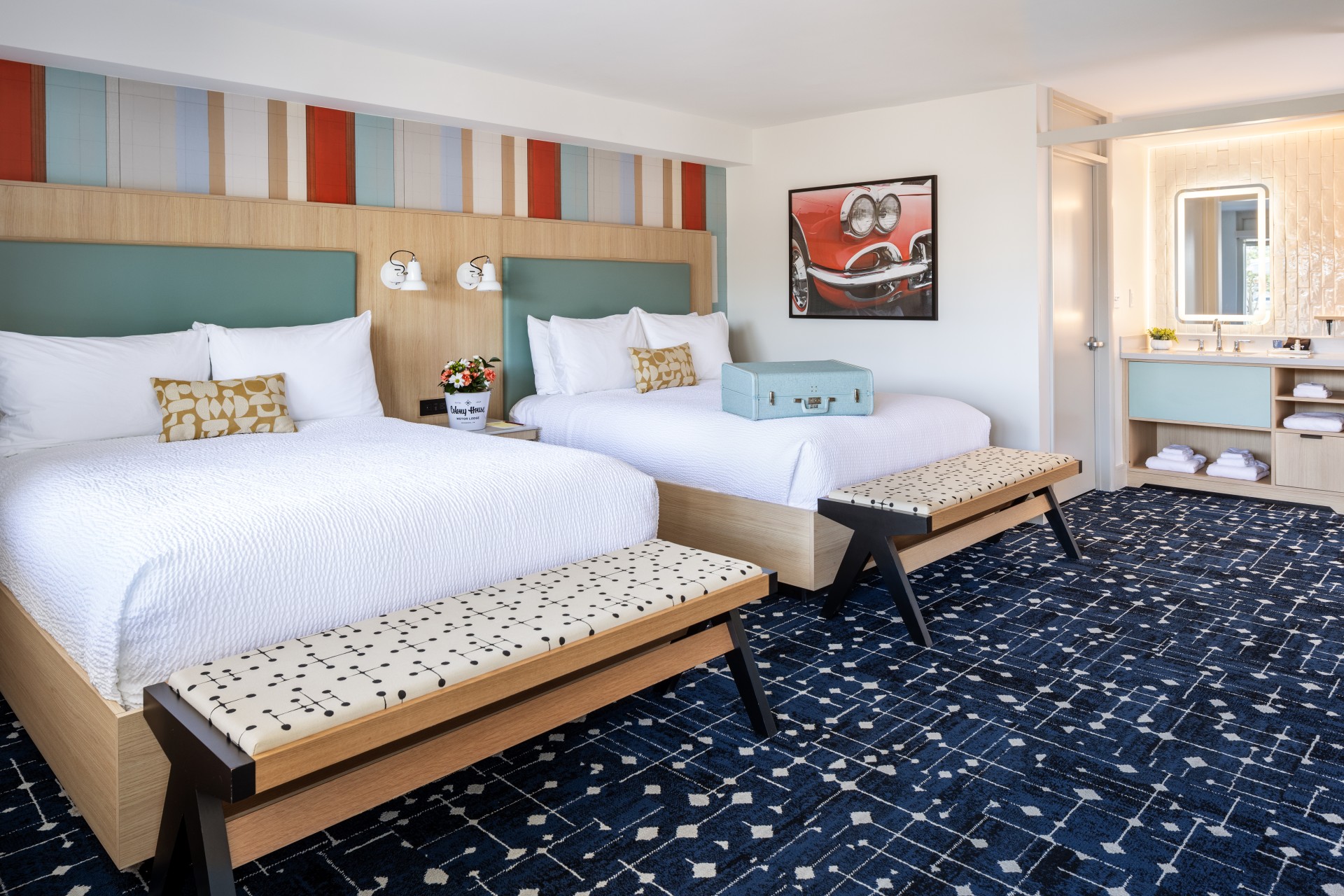 a room with two beds and a blue carpet