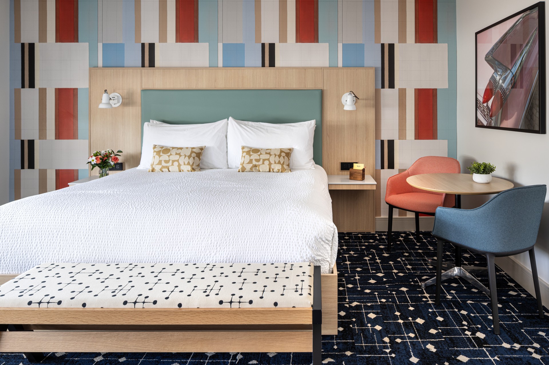 a bed with a table and chairs in a hotel room
