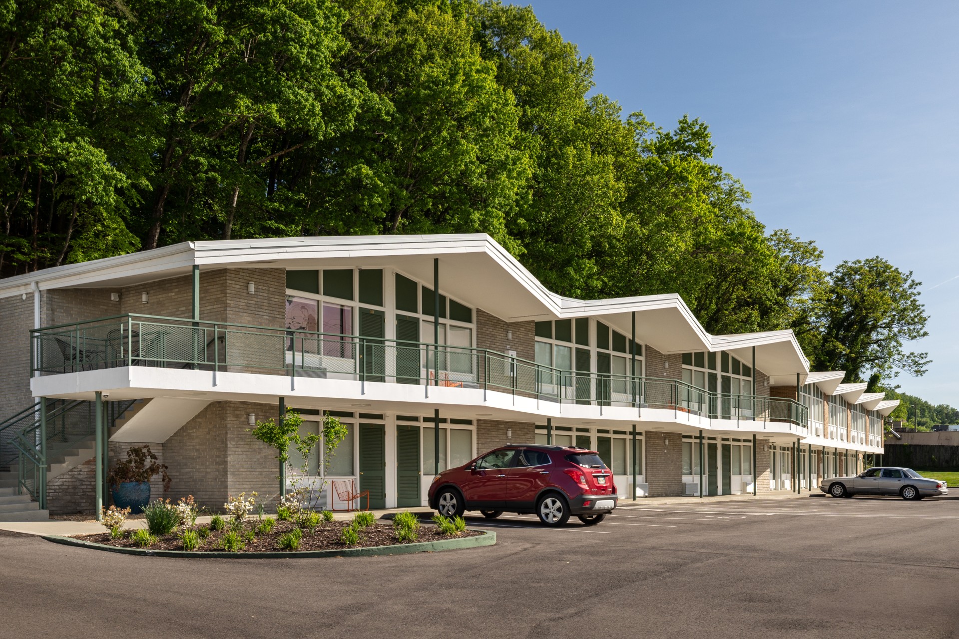 a building with a red car parked in front of it