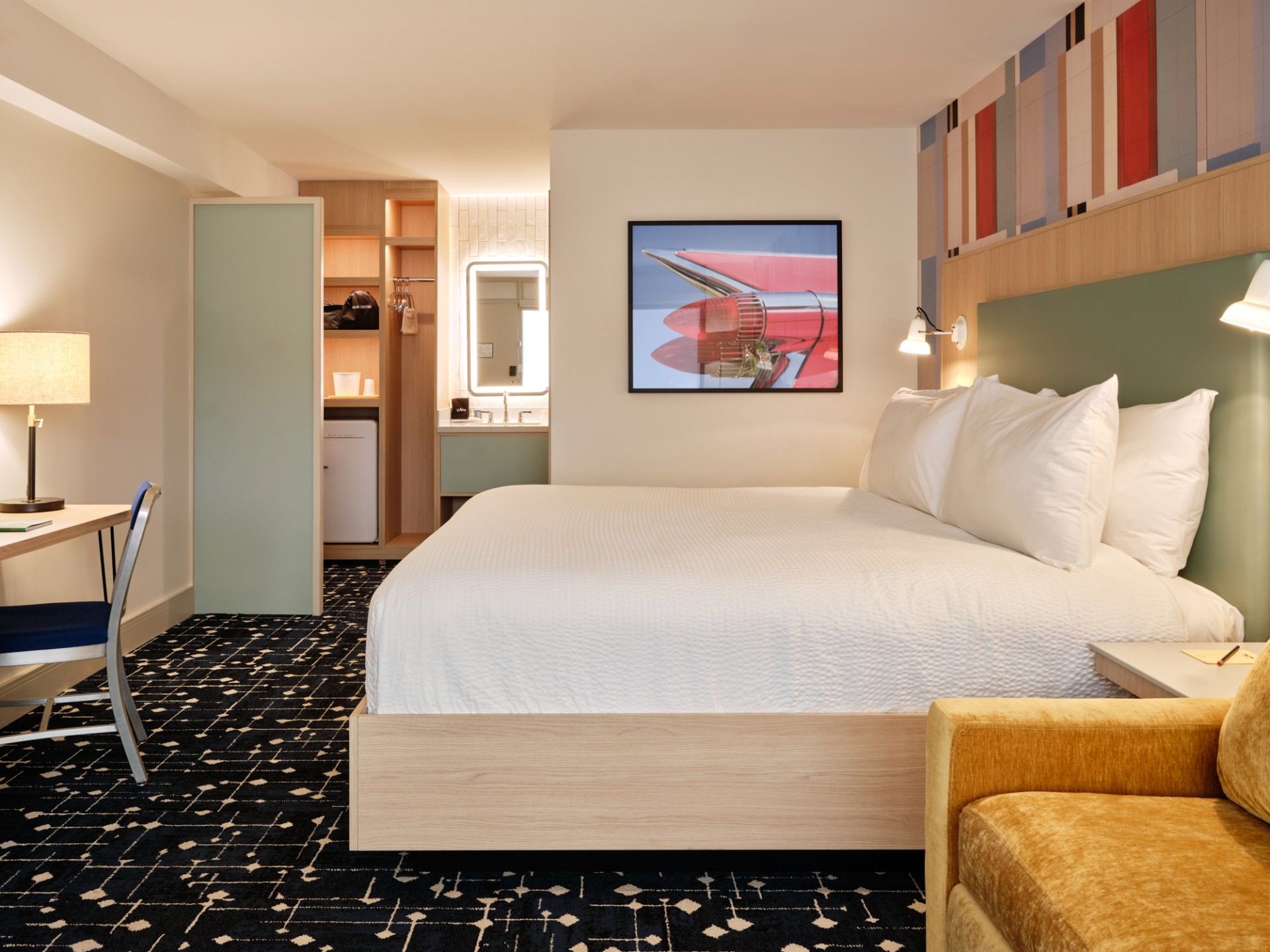 a room with a bed and a picture on the wall