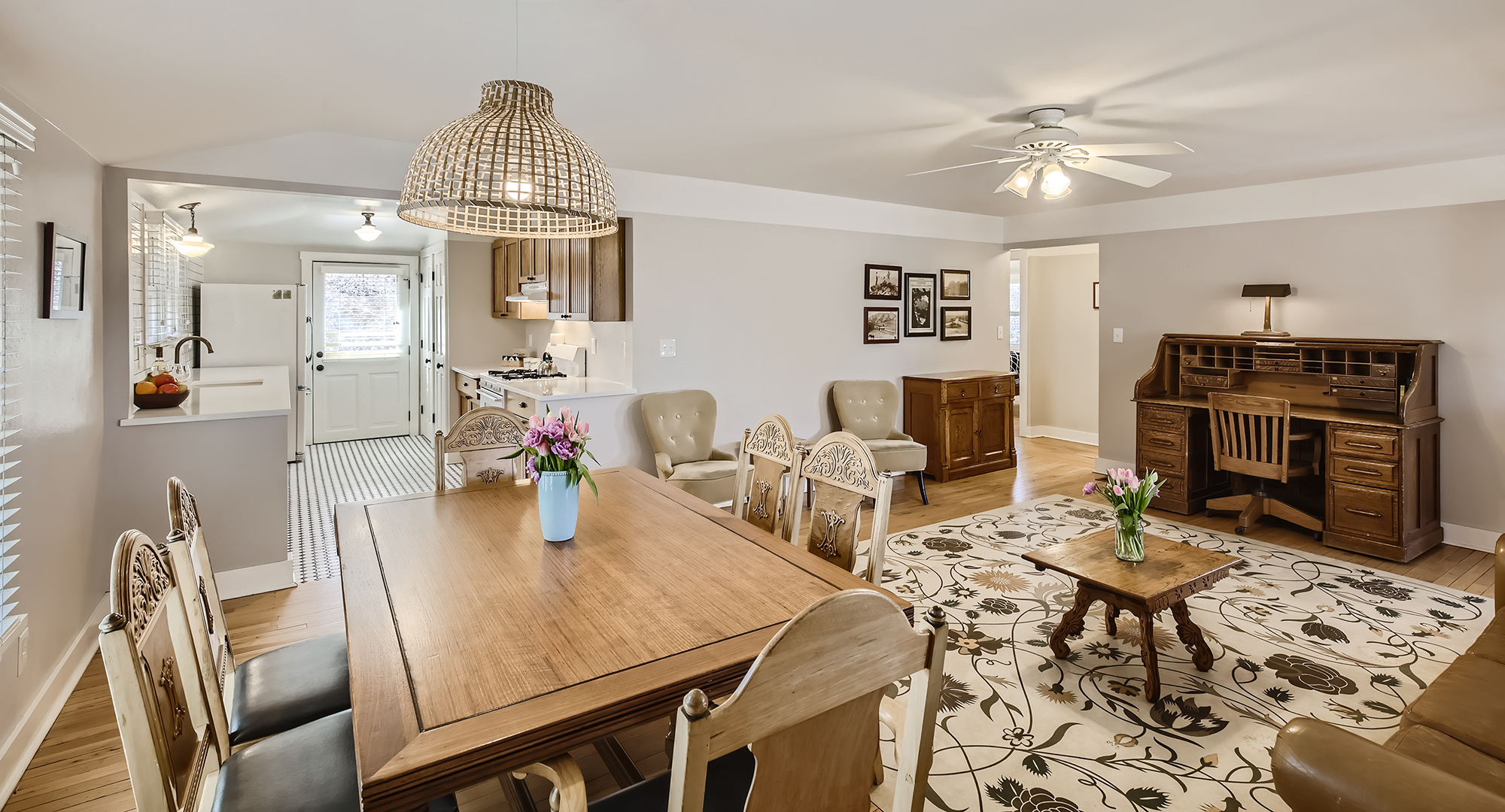 a living room with a dining table and chairs