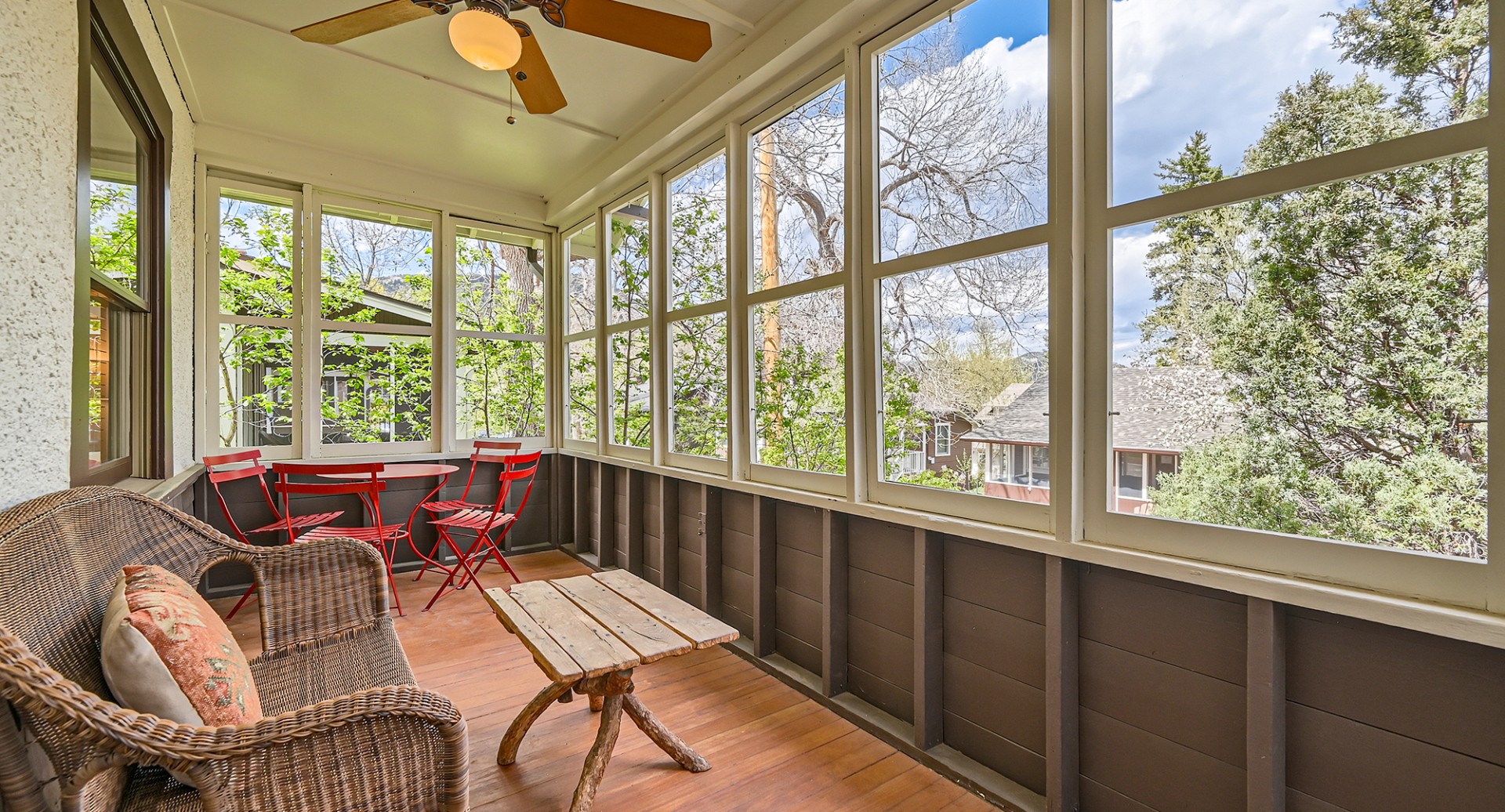 a porch with a table and chairs