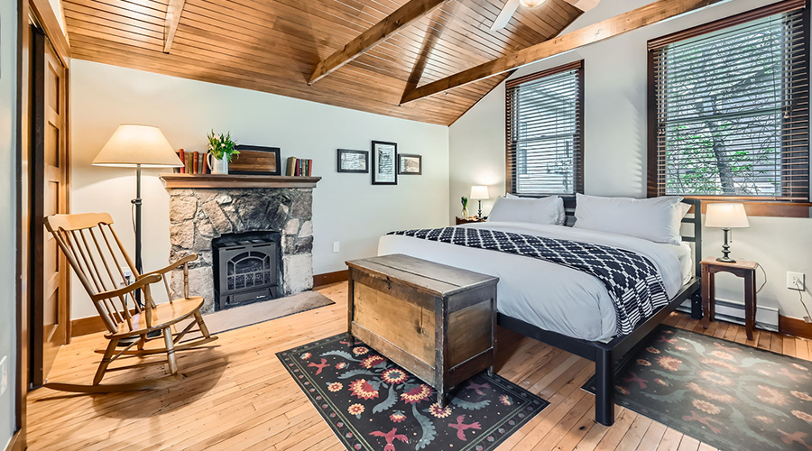a bedroom with a fireplace and a bed