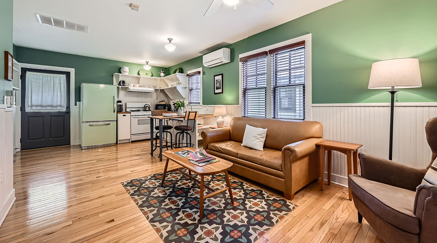 a living room with a couch and kitchen