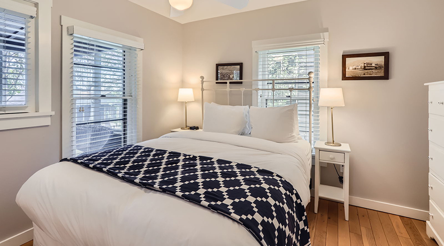 a bed with a white bed and a black and white blanket