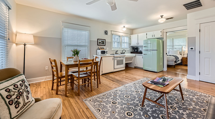 a kitchen and dining room with a table and chairs