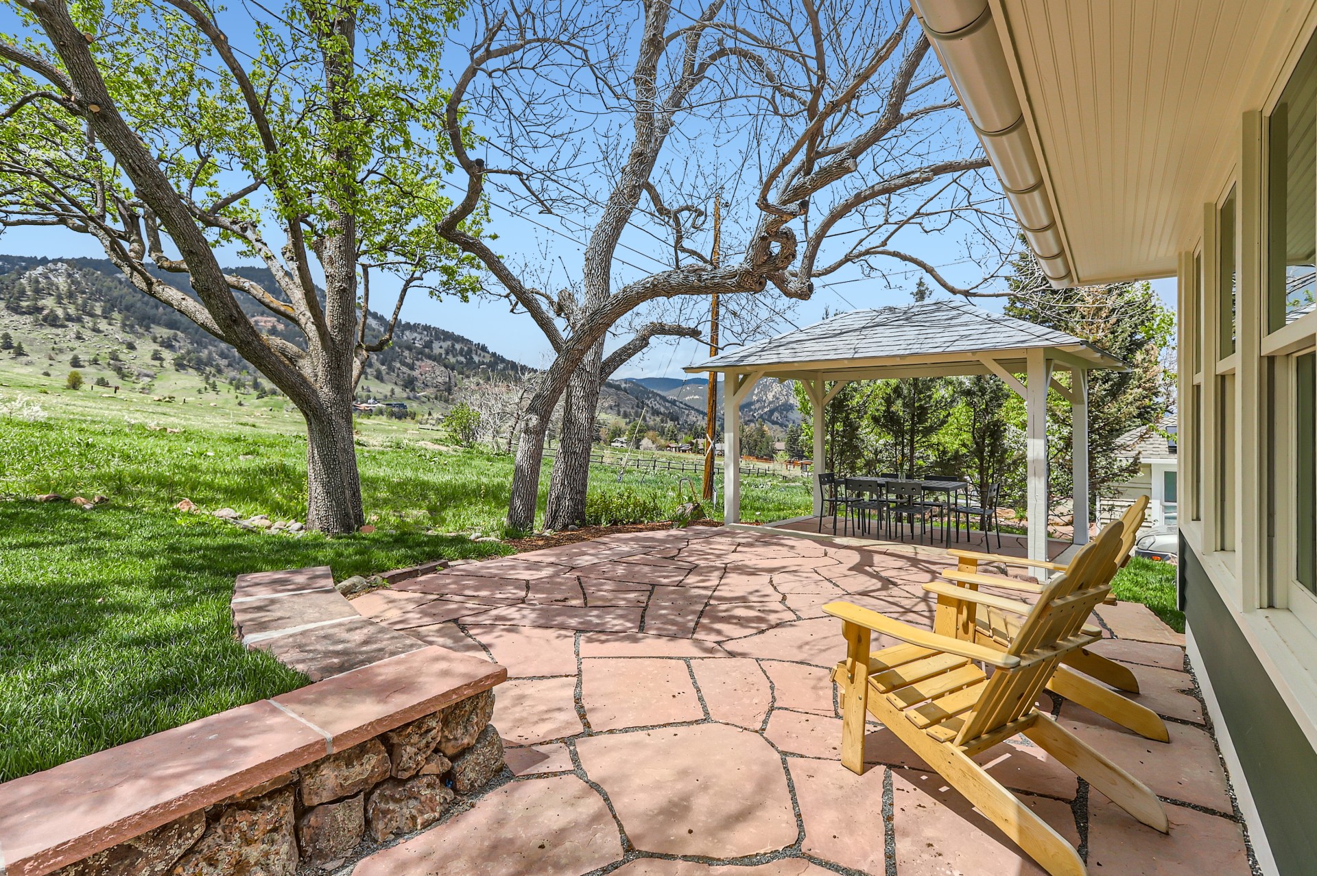 a patio with a gazebo and chairs