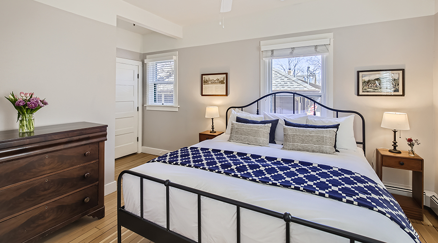 a bedroom with a bed and a fan