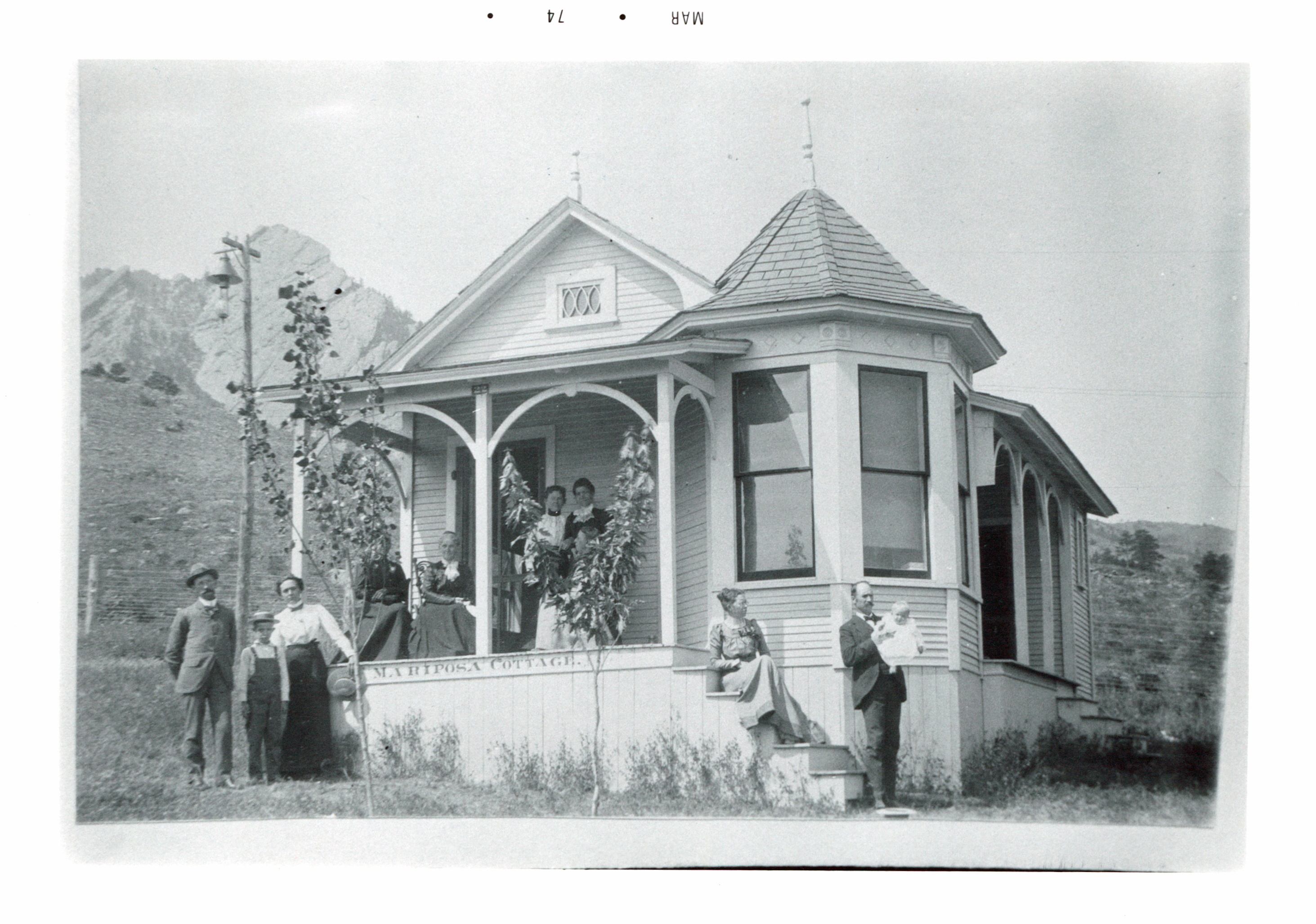 a group of people standing on a porch of a house